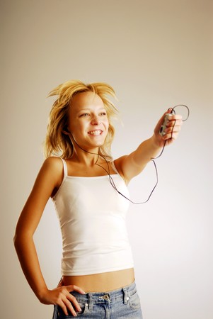 A young blonde girl listening to musicの写真素材
