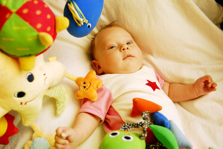 A baby sleeping in a bed