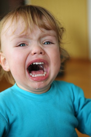 The portrait of little blonde crying boy.の写真素材