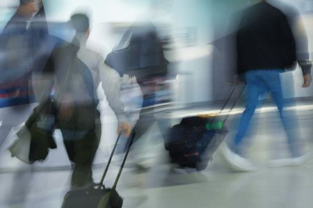 People hurrying in the airport.の写真素材