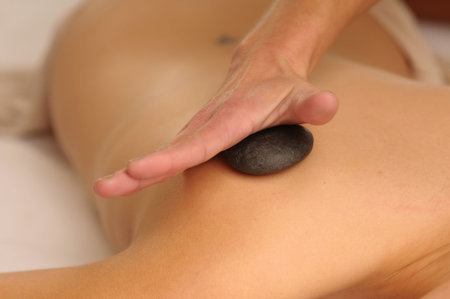 The attractive woman during the masage with stones.