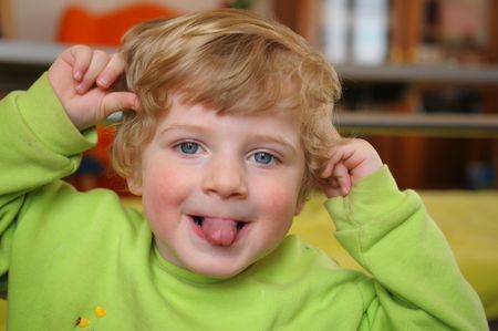The portrait of little boy with stuck out tongue.の写真素材