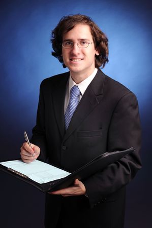 The portrait of young attractive businessman in dark suit.の写真素材