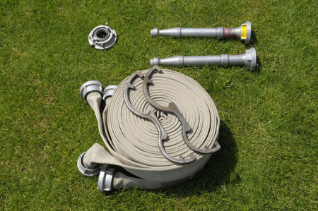 The involved fire hosepipe and accessory on green grass