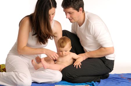 The long black-haired mother, father and their little boyの写真素材