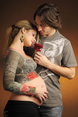 The portrait of future parents with red roseの写真素材