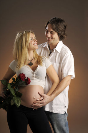 The portrait of future parents with red rose