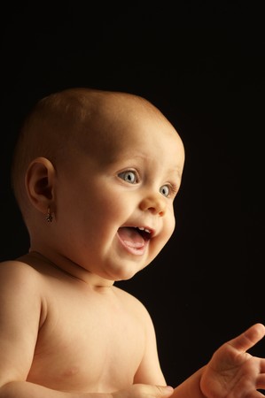 The portrait of the little beautiful girl in nappy on dark backgroundの写真素材