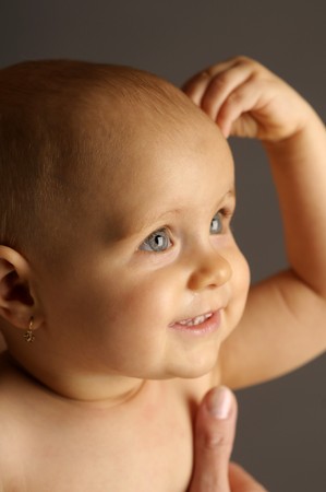 The portrait of the little beautiful girl in nappy on dark backgroundの写真素材