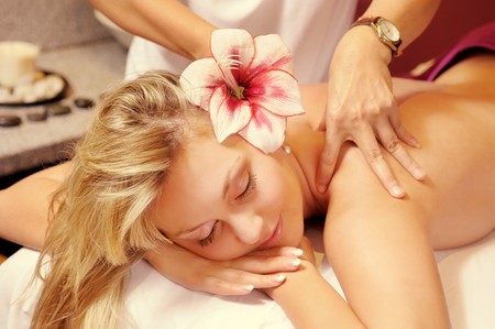 The attractive young woman with flower during the Thai massageの写真素材