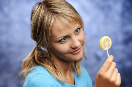 The young woman with two tails and with lollypopの写真素材