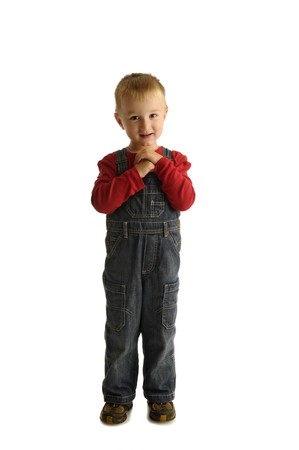 Smiling little boy in red shirt and blue jeansの写真素材
