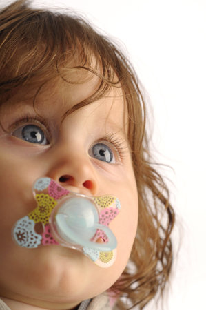 Portrait of a little girl with a teat on white background