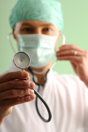 Young doctor showing a stethoscopeの写真素材