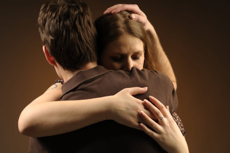 Couple in an embrace on an dark background