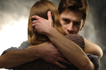 Couple in an embrace on an gray background