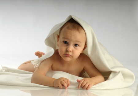 Picture of one cute little child lying ont the floorの写真素材