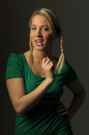 Picture of young woman pulling gum from her mouthの写真素材