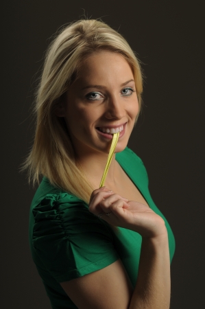 Picture of young woman pulling gum from her mouthの写真素材