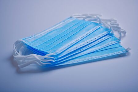 Zdravotnicka rouska, ochrana proti koronaviru --- Medical protection face mask on blue background - Covid 19 protectionの写真素材