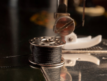 Soviet black sewing machine Spool of thread close-up Sewing workshop conceptの写真素材