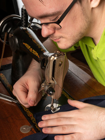 The master prepares the sewing machine for work Preparing for sewing clothes Sewing workshop conceptの写真素材
