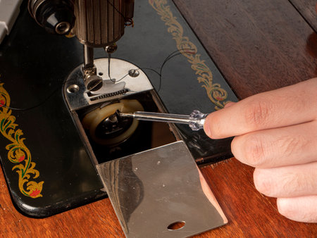 The master prepares the sewing machine for work Preparing for sewing clothes Sewing workshop conceptの写真素材