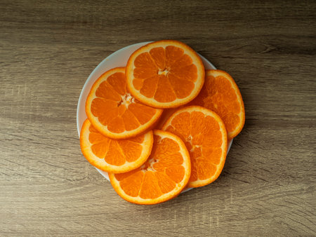 Orange slices on a wooden gray table on a dark background Fresh juice conceptの写真素材