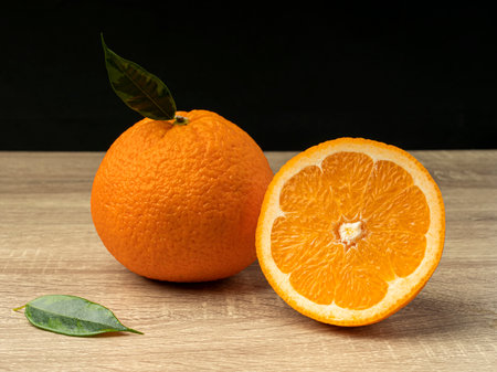 Orange slices on a wooden gray table on a dark background Fresh juice conceptの写真素材