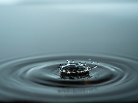 Splashing a drop of water into the aquarium. Colorful water dropの写真素材