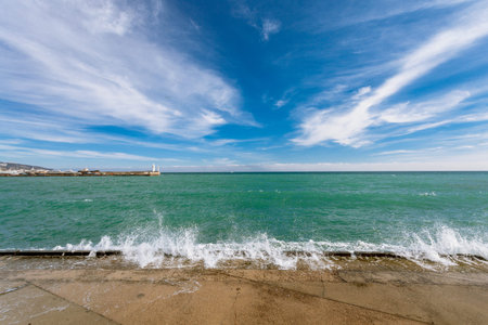 Views of the waterfront and waves of the sea in the Bay of Yalta in the winter sunny day. Yalta....