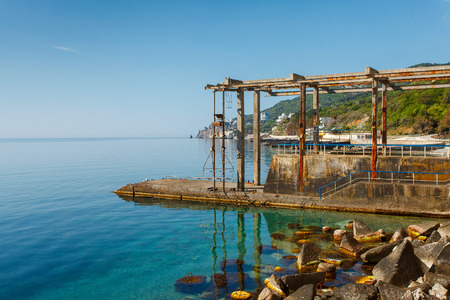 The old boat station on coast of the southern coast. Beautiful and calm morning sea. Yalta. Crimea. Russia. Ukraineの写真素材