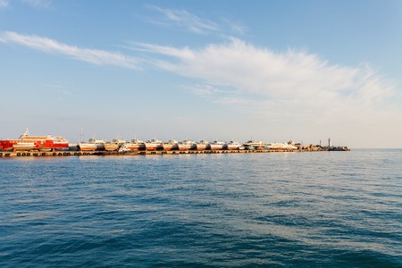 Pleasure boats standing in a row on the beach, waiting for the tourist season. On the waterfront of the city of Yalta. Crimea. Ukraine. Russiaの写真素材