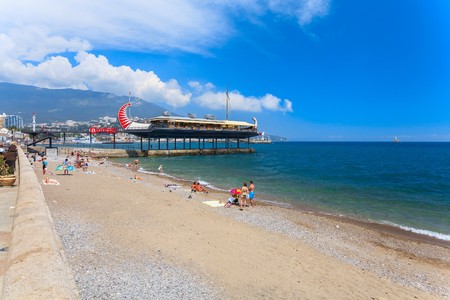 YALTA - MAY 17: People are walking along the Lenina Embankment with boutiques buildings on May 17, 2013 in Yalta, Ukraine.Russia.のeditorial素材