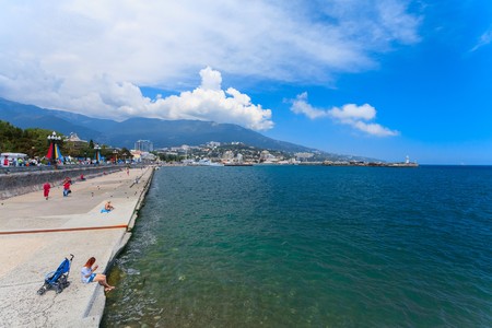 YALTA - MAY 17: People are walking along the Lenina Embankment with boutiques buildings on May 17, 2013 in Yalta, Ukraine.Russia.のeditorial素材