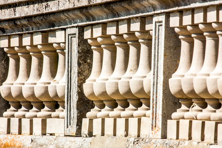 Ancient marble balustrade in front of the facade of the palaceの写真素材