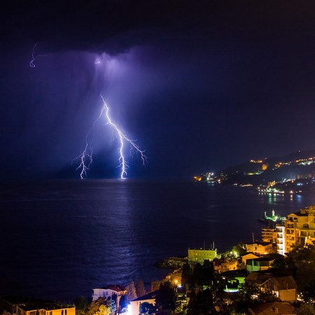 Lightning into the sea over the night city. Yalta. Crimea. Ukraine. Russiaの写真素材