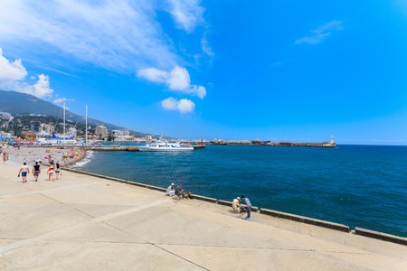 YALTA - MAY 17: People are walking along the Lenina Embankment with boutiques buildings on May 17, 2013 in Yalta, Ukraine.Russia.のeditorial素材