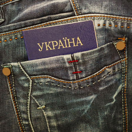 Ukrainian passport in jeans pocket close up.の写真素材