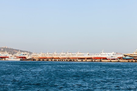 Pleasure boats lined up in a row on the quay port of Yalta, Russiaのeditorial素材