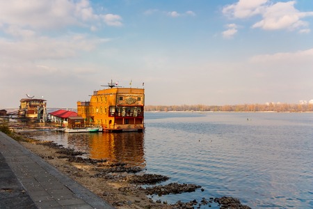 Kiev, Ukraine- 30 October, 2010: Old ruined cafes and restaurants on the banks of the Dnieper River and the background of the city Kievのeditorial素材
