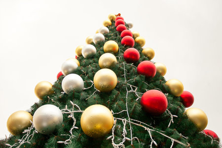 Christmas toys are on the Christmas tree. New year on white background, it's glass ball and tree...