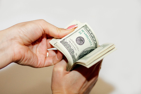 The money is in women's hand. Hand with money, banknotes in hand, counting banknotes.の写真素材