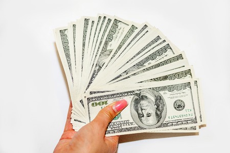 The money is in women's hand. Hand with money, banknotes in hand, counting banknotes.の写真素材