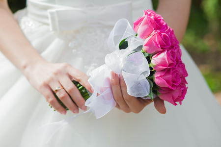 Beautiful wedding bouquet in hands of the brideの写真素材
