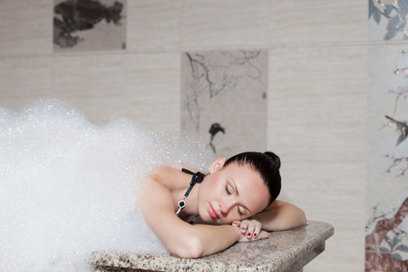 Young woman having massage in hamamの写真素材