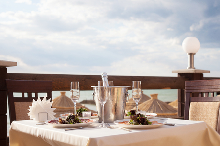 Fine restaurant dinner table place setting: wineglass, shampagneの写真素材