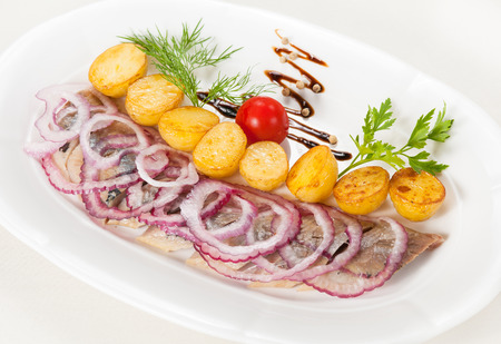 Boiled potato with a herring and an onionsの写真素材
