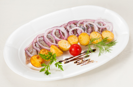 Boiled potato with a herring and an onionsの写真素材