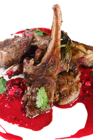 roasted lamb ribs with caramel sauce on a plateの写真素材